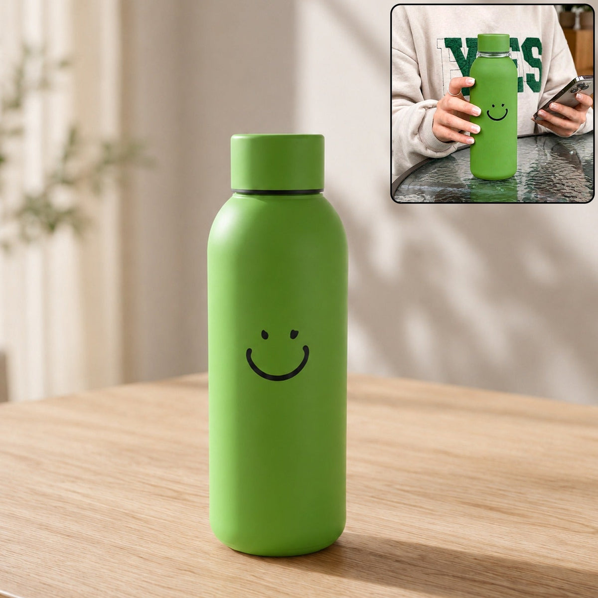 Green glass water bottle with a smiley face on a wooden table, with an inset showing a person holding a similar bottle.