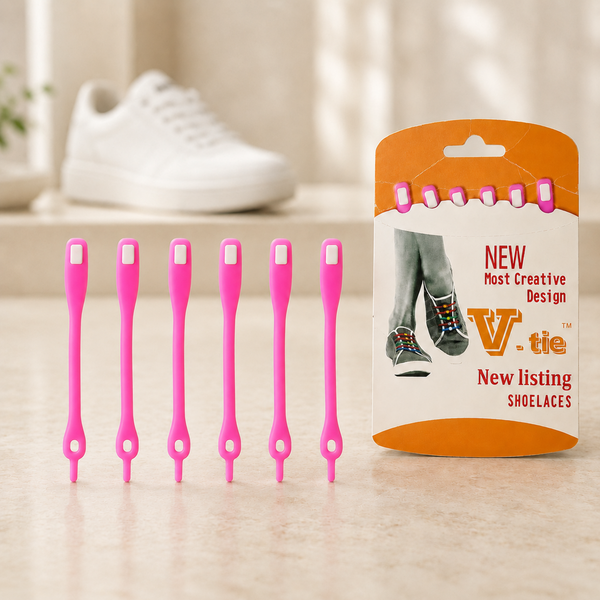 Six pink silicone no-tie shoelaces with white accents, next to their orange and white packaging. A white shoe is blurred in