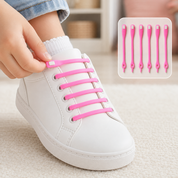A child's foot in a white sneaker with pink silicone no-tie shoelaces, being adjusted by a hand.